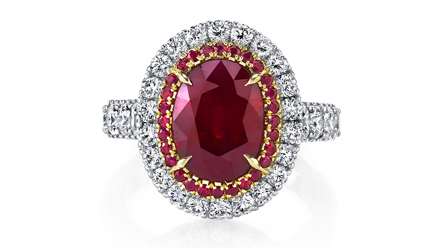 The 5.00 ct oval ruby in this designer ring is set in platinum with 18k rose gold, surrounded by halos of round rubies and diamonds.