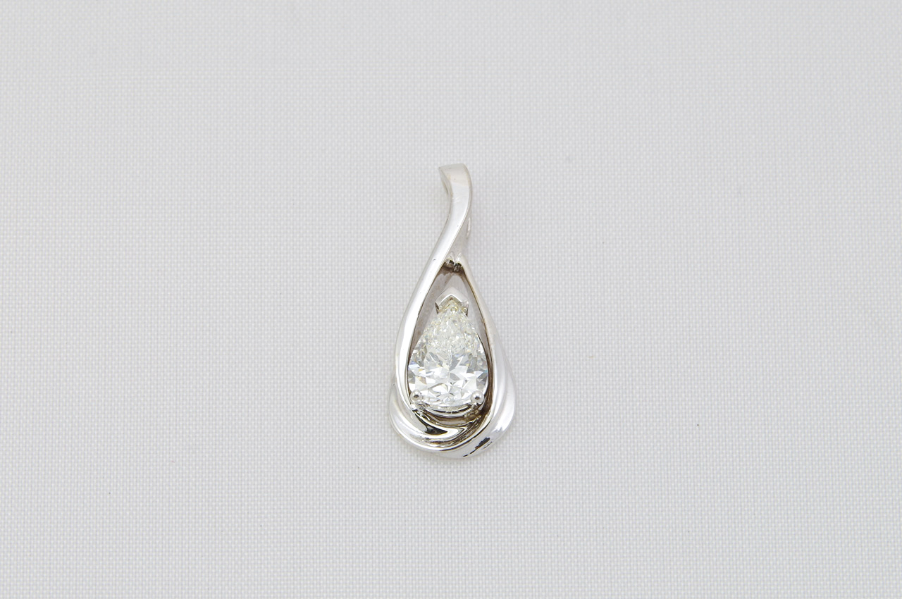 14k white gold drop Diamond pendant, with one H color, SI1 clarity, pear-shape brilliant cut Diamond. The Diamond weighs 1.18 carats, measures 8.7 mm wide by 5.89 mm long by 3.95 mm deep, has no fluorescence, excellent polish and very good symmetry, and i